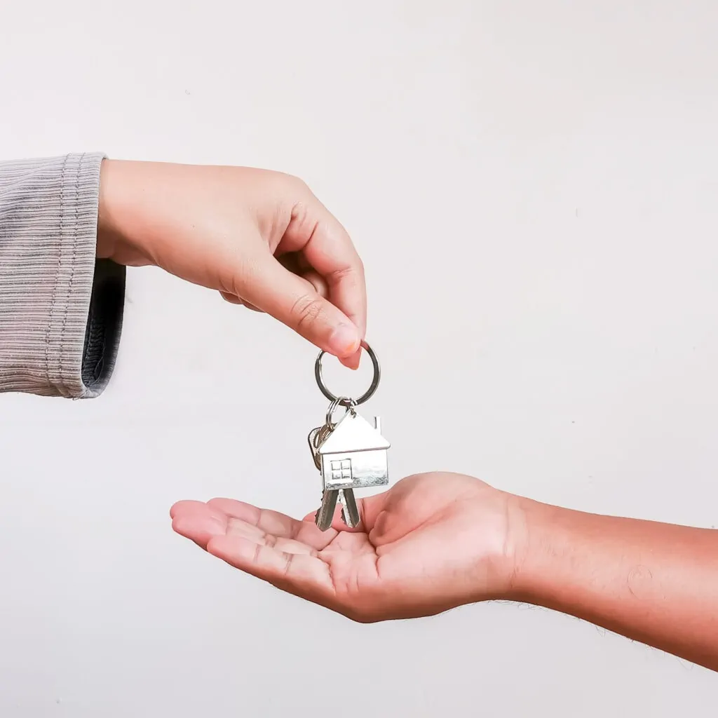 hand passing a set of house keys to another hand 2022 11 10 00 58 35 utc